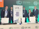 The participants of the COP28 side event "Innovative policies for the path to climate neutrality" stand behind the podium