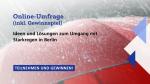 Promotional graphic for an online survey about ideas and solutions for dealing with heavy rainfall in Berlin. The text reads: "Online-Umfrage (inkl. Gewinnspiel). Ideen und Lösungen zum Umgang mit Starkregen in Berlin. TEILNEHMEN UND GEWINNEN!" The background features a close-up image of raindrops on a red umbrella.