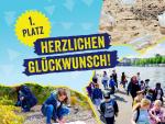 Collage showing children and adults taking part in a litter collection activity by a river, alongside plastic waste on a beach. The central text reads “1st Place – Congratulations!”.